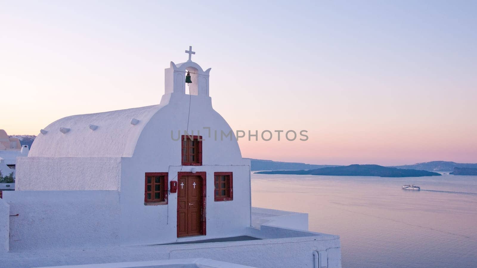 Greek church in santorini greece with a cross