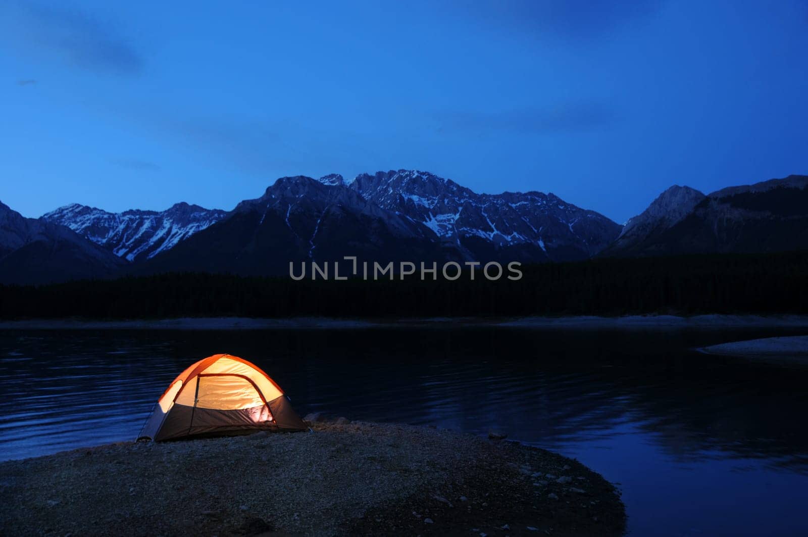 Evening lit tent in camping by nature