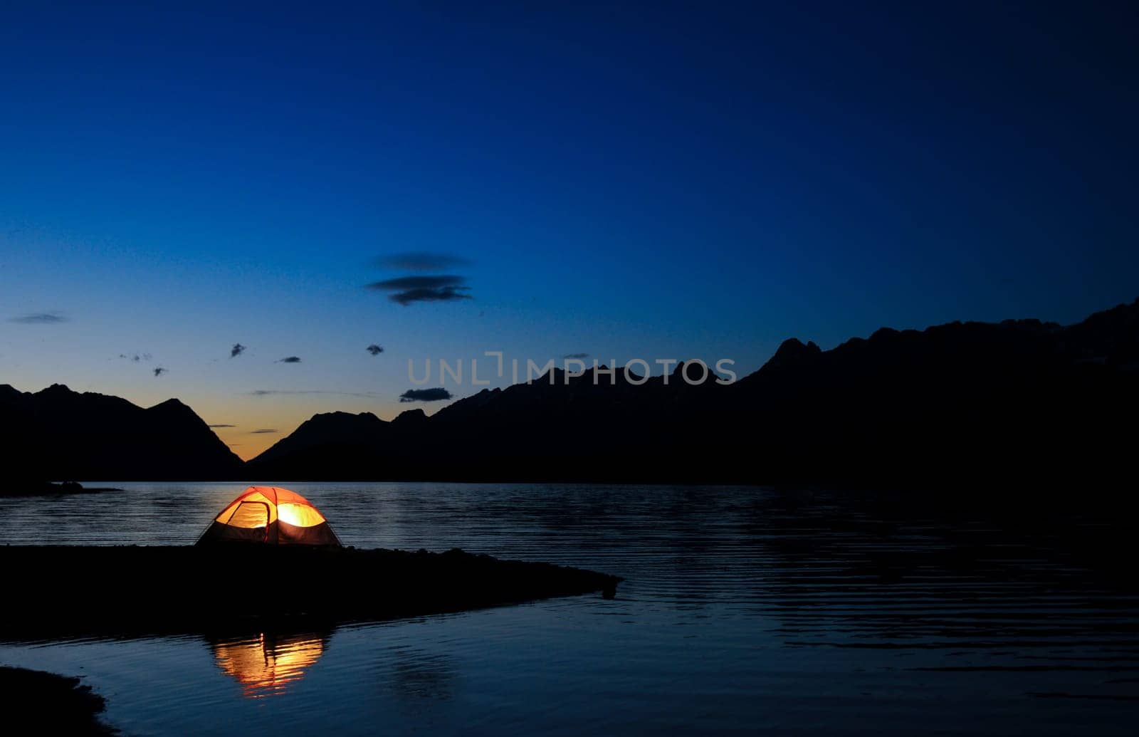 Evening lit tent in camping by nature