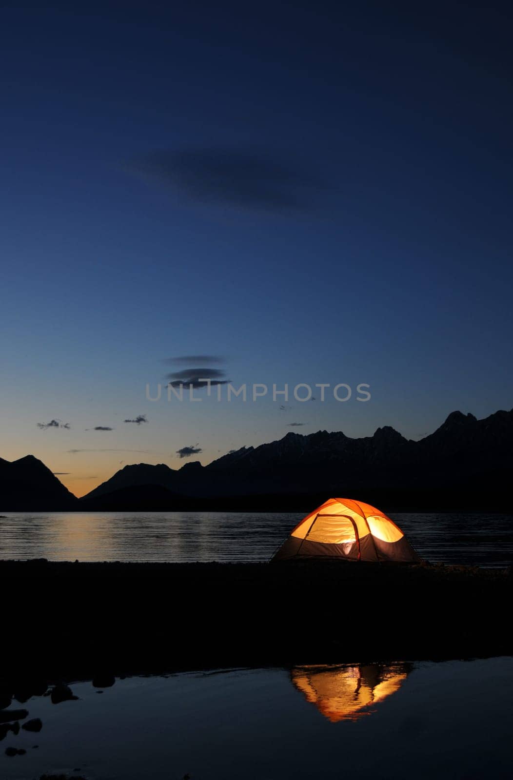 Evening lit tent in camping by nature