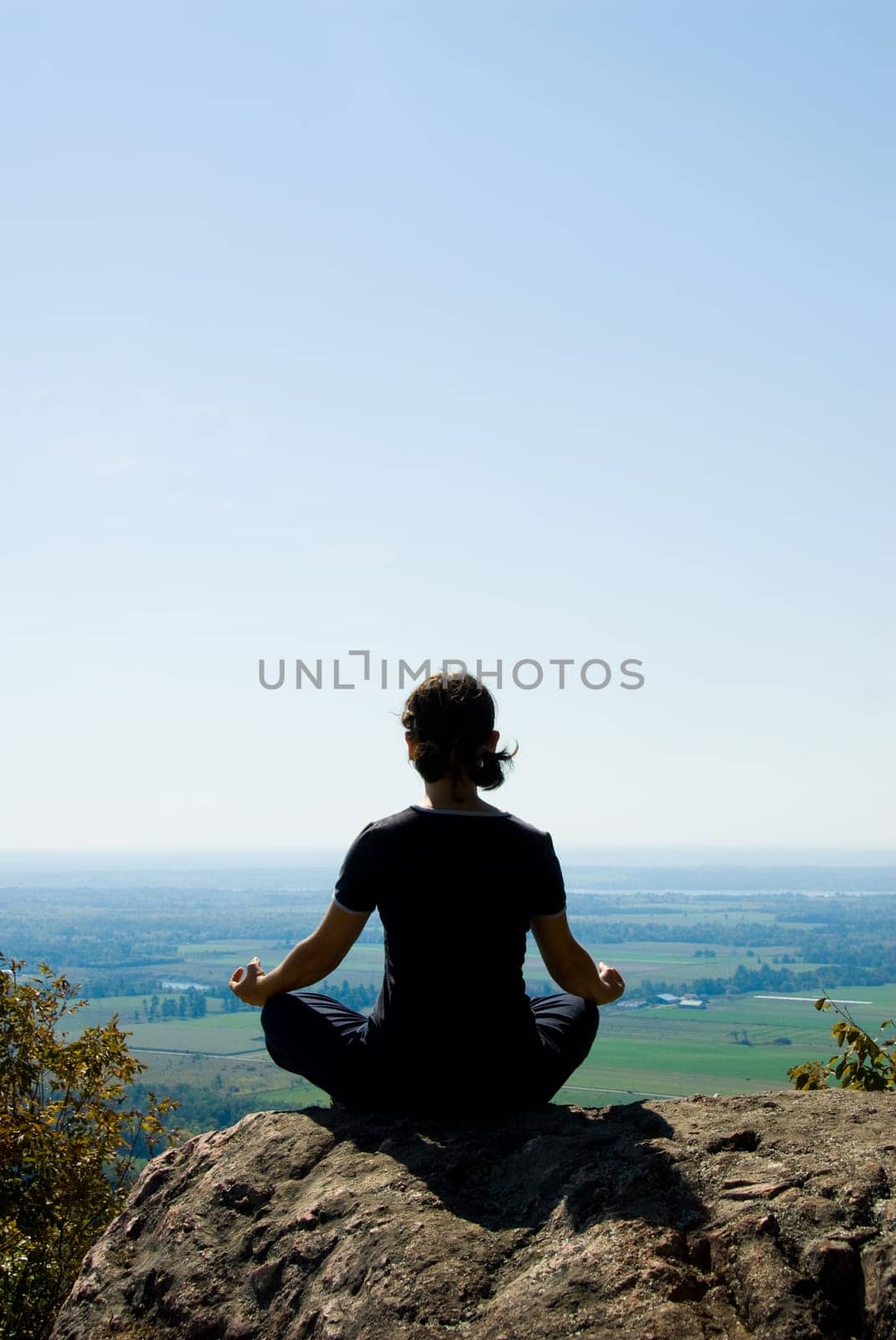 Woman on the top of a mountain relaxing