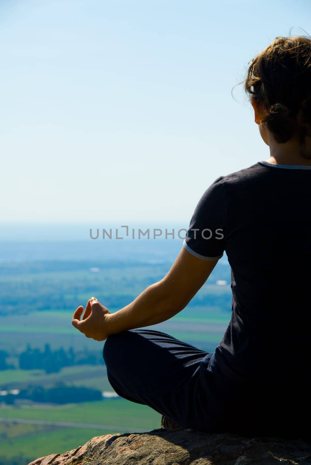Woman on the top of a mountain meditation