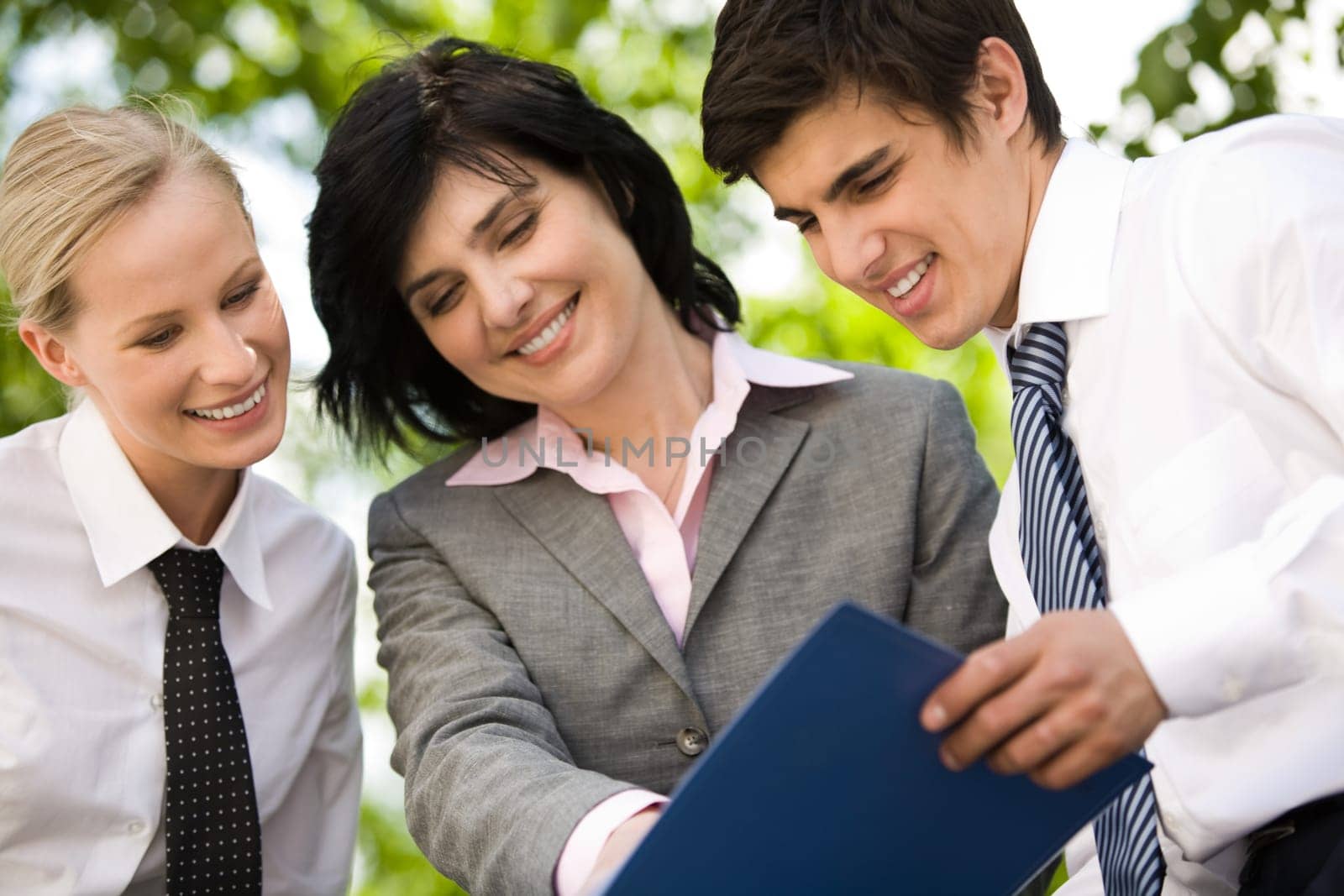 Portrait of busy people planning their work together outside at summer