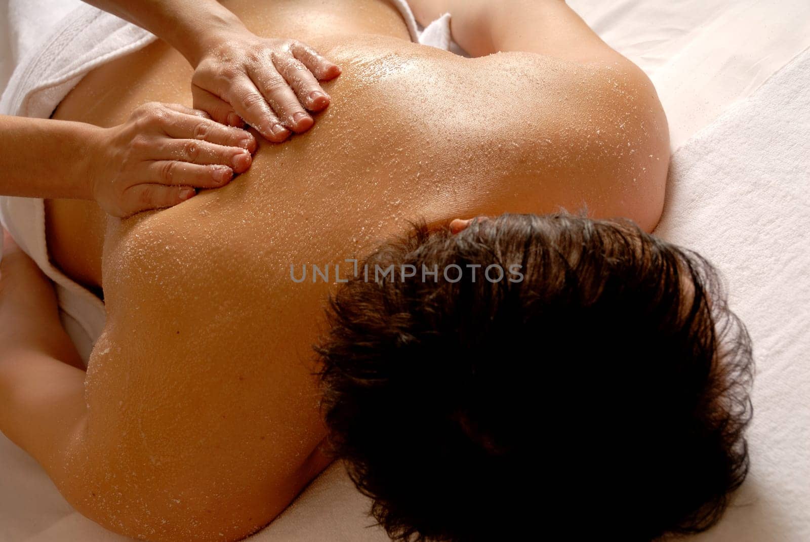 salt massage given by a therapist in a spa