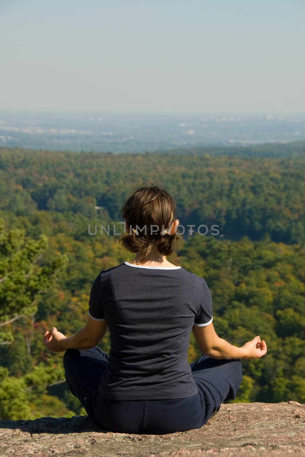 Woman on the top of a mountain meditating