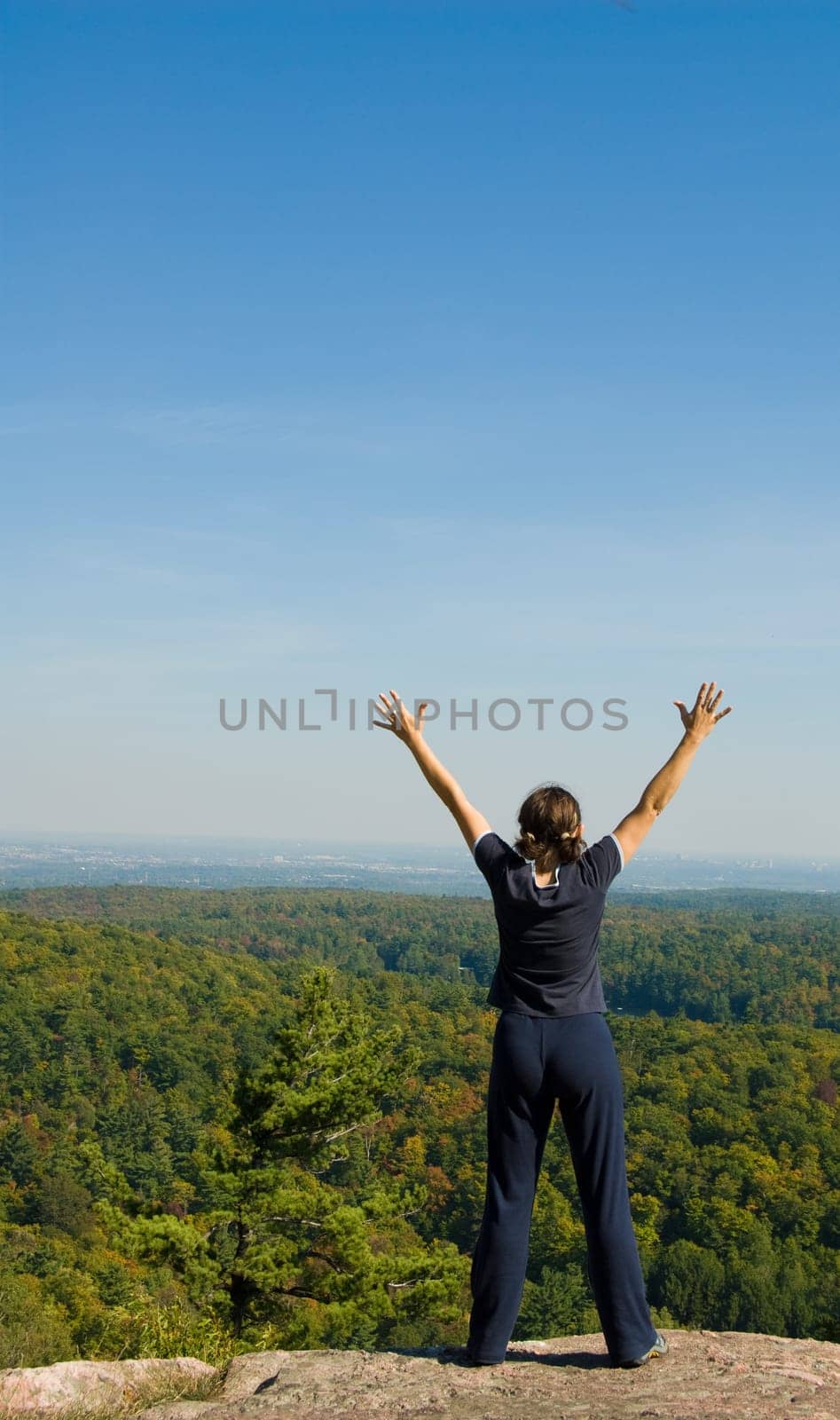 Woman on the top of a mountain happy