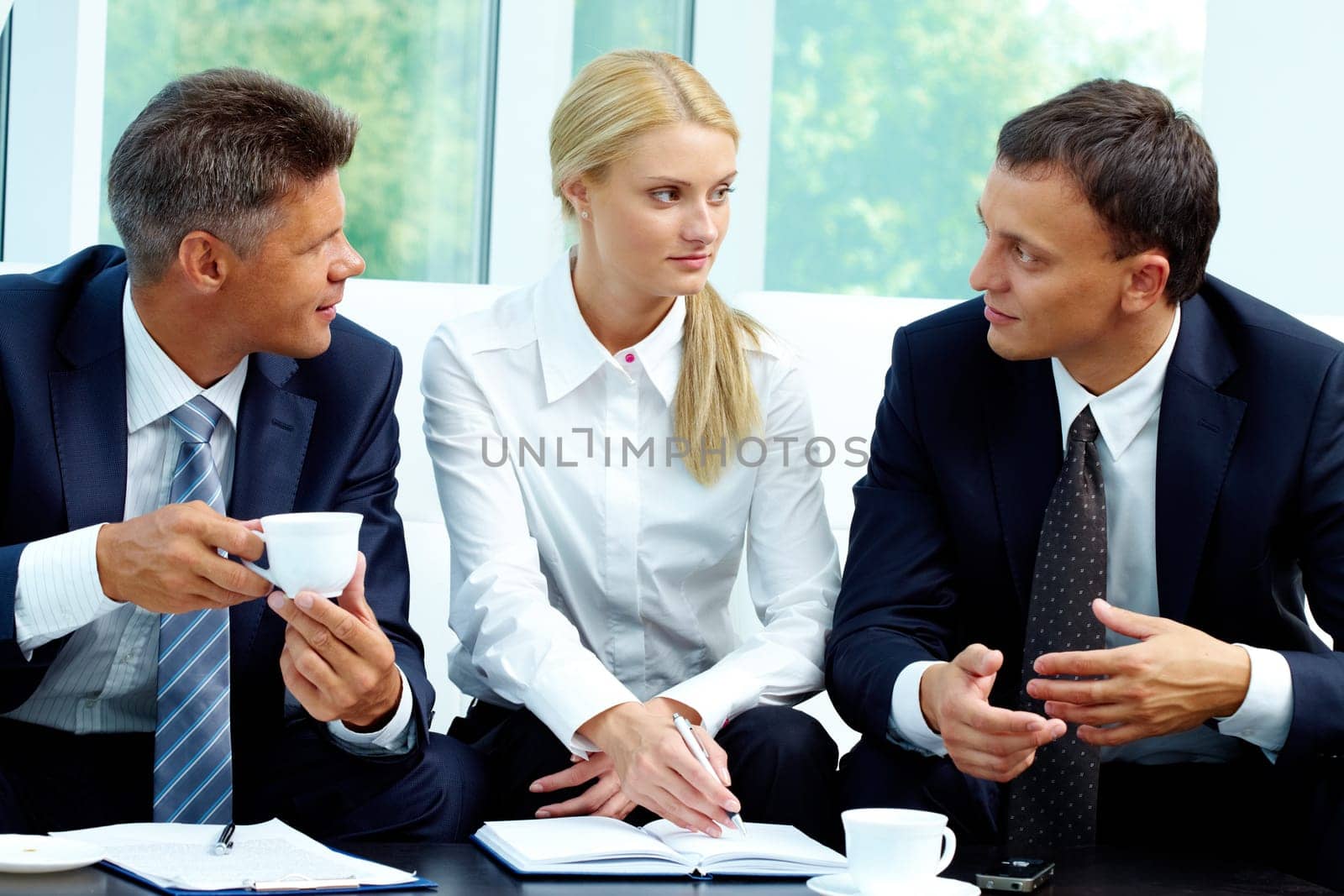 Image of successful partners discussing new ideas and strategies at meeting
