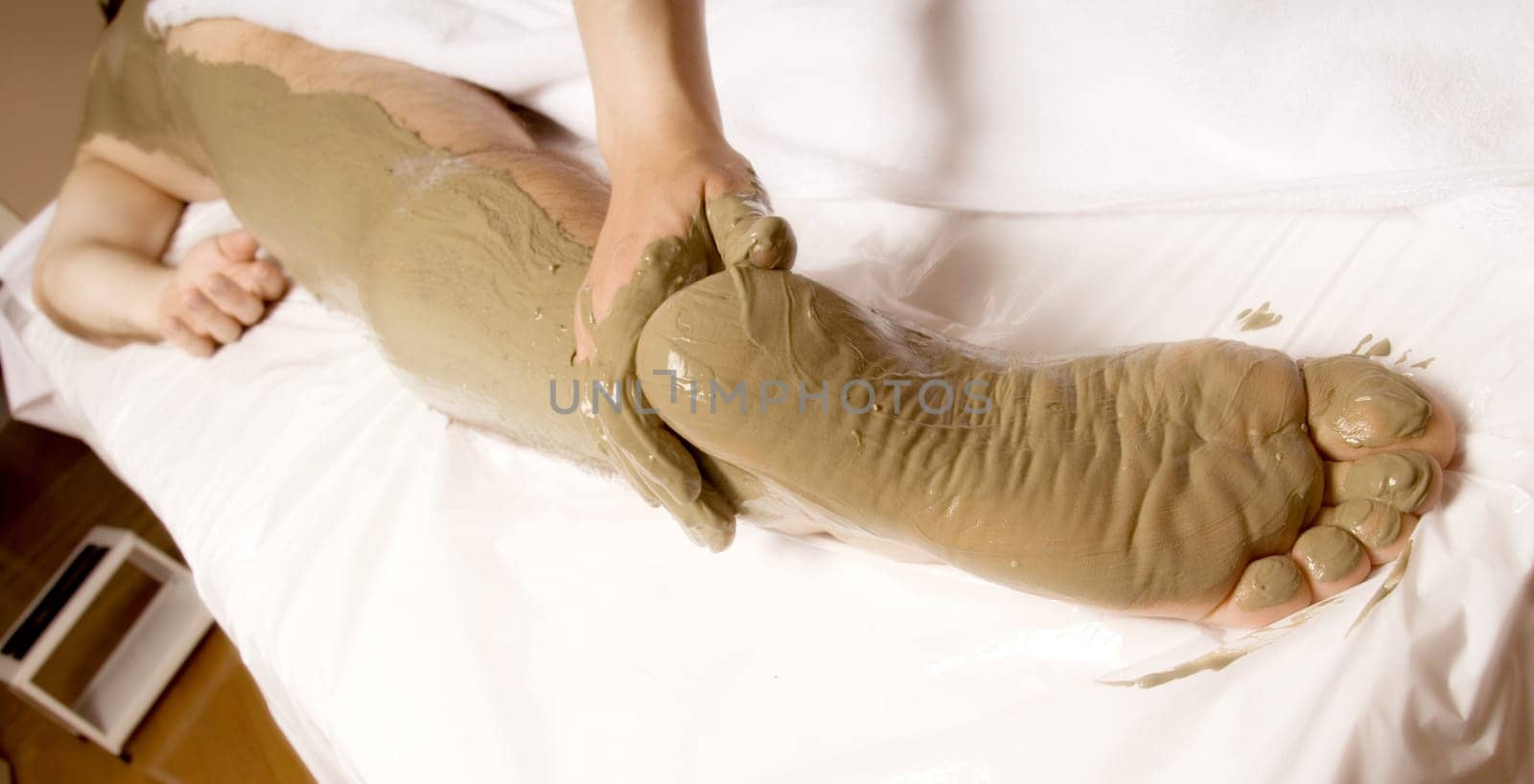 man client getting a Full body mud wrap