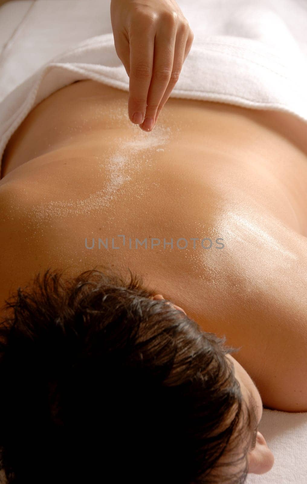 therapist giving a salt treatment to the client