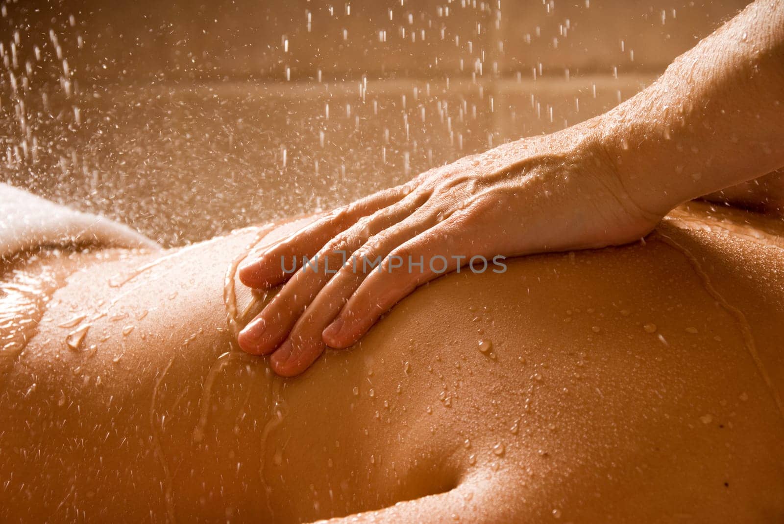 woman getting a rain massage in a day spa