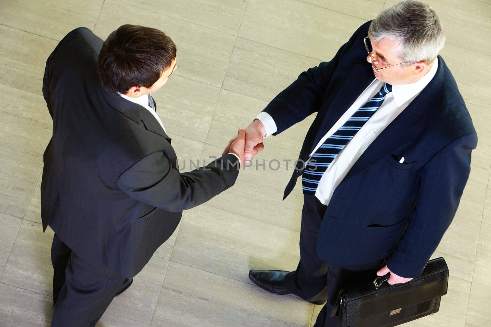 High angle view of two businessmen shaking hands