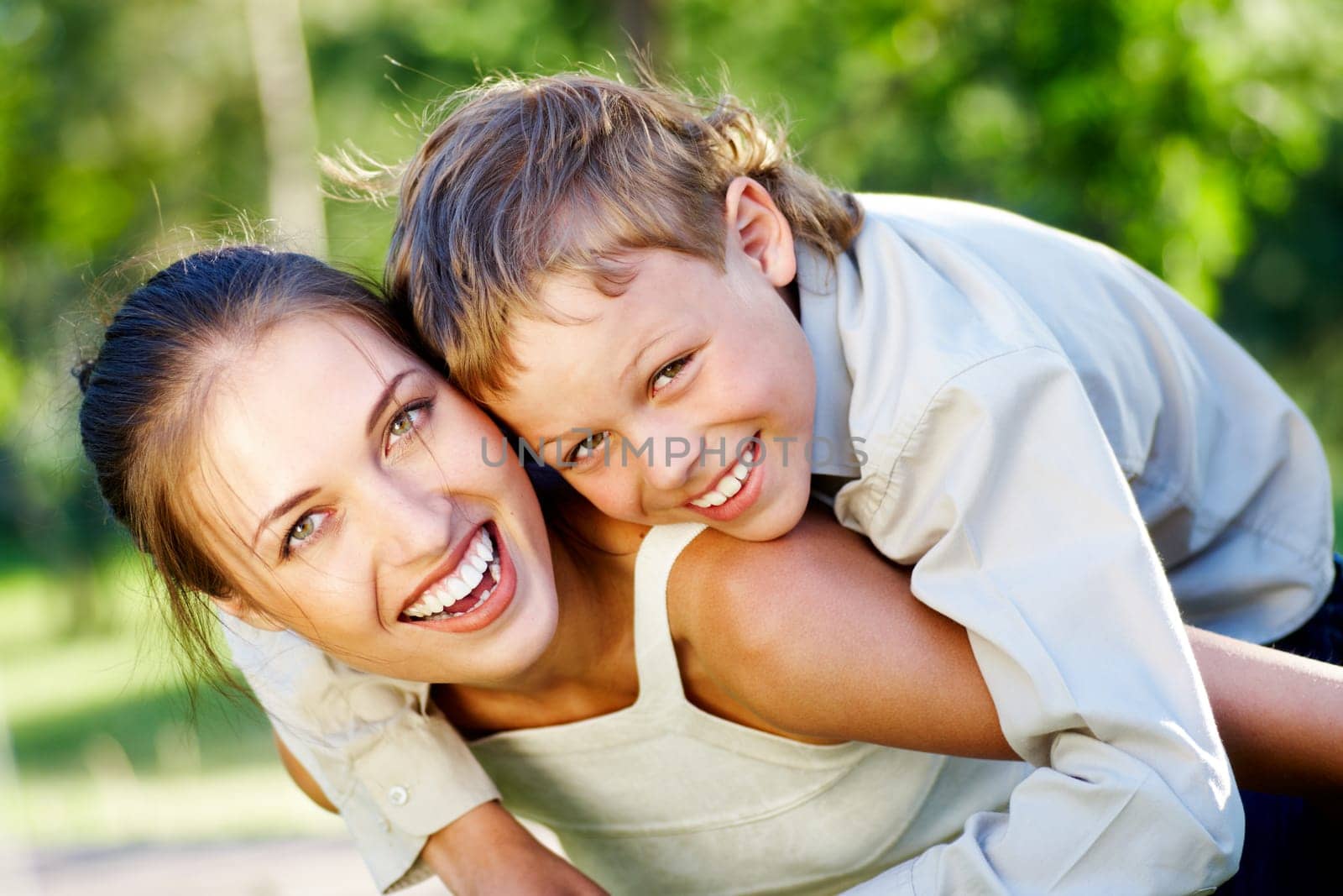 Happy mother holding her cute son and both laughing