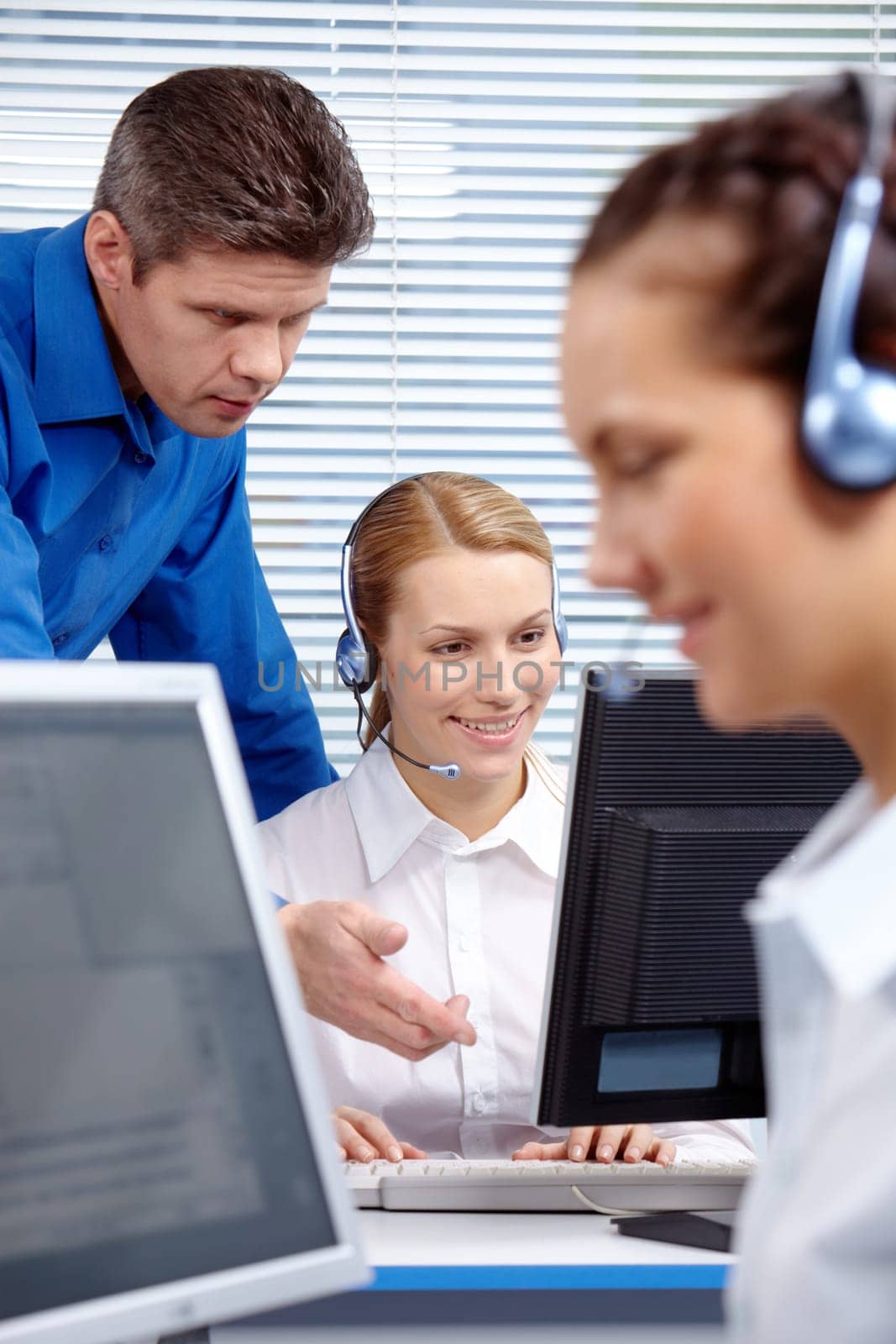 Image of boss explaining work to telephone consultant in the office