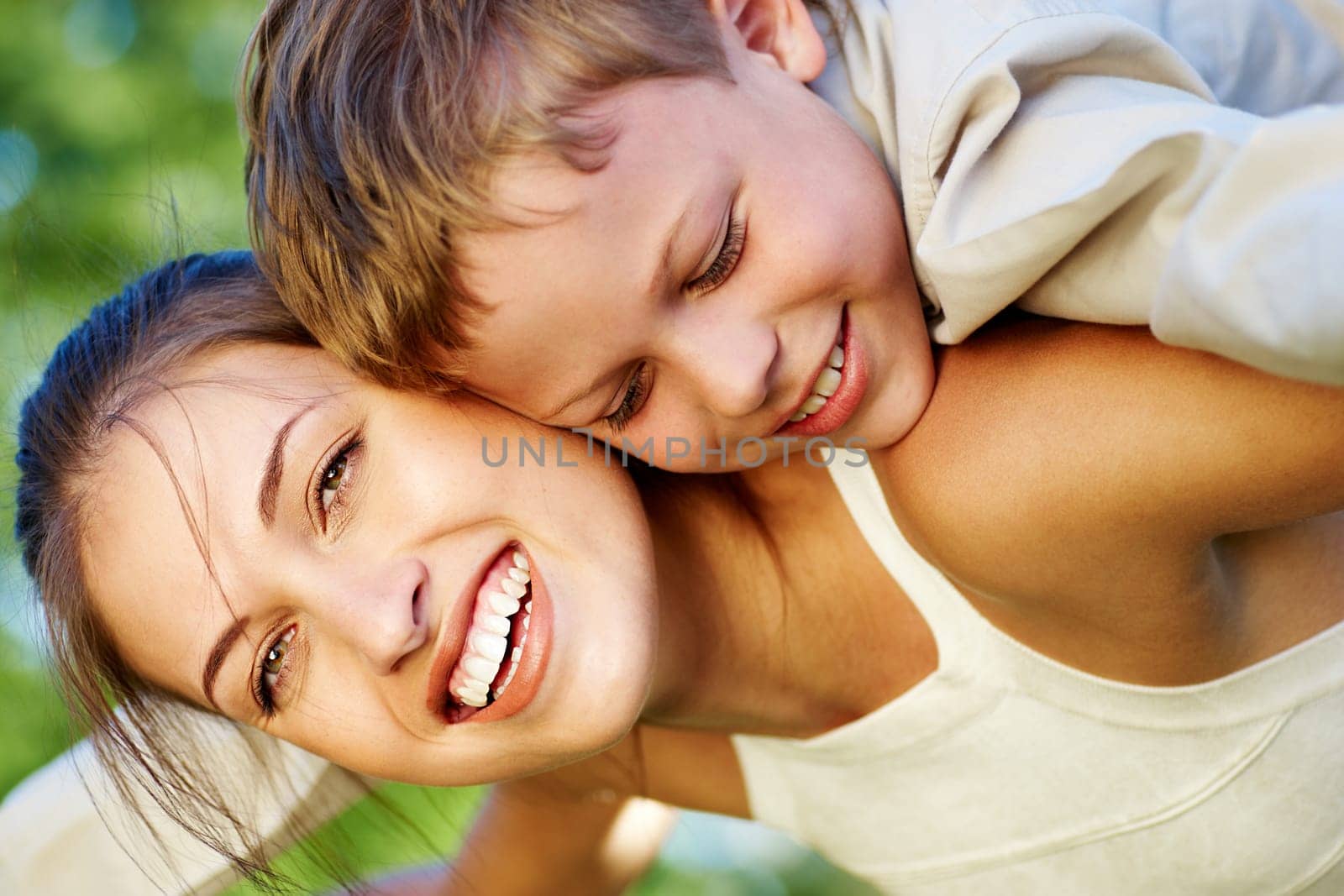 Happy mother holding her cute son and laughing