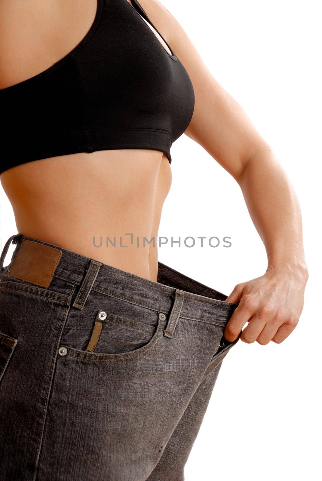 female wearing old jeans who has lost weight