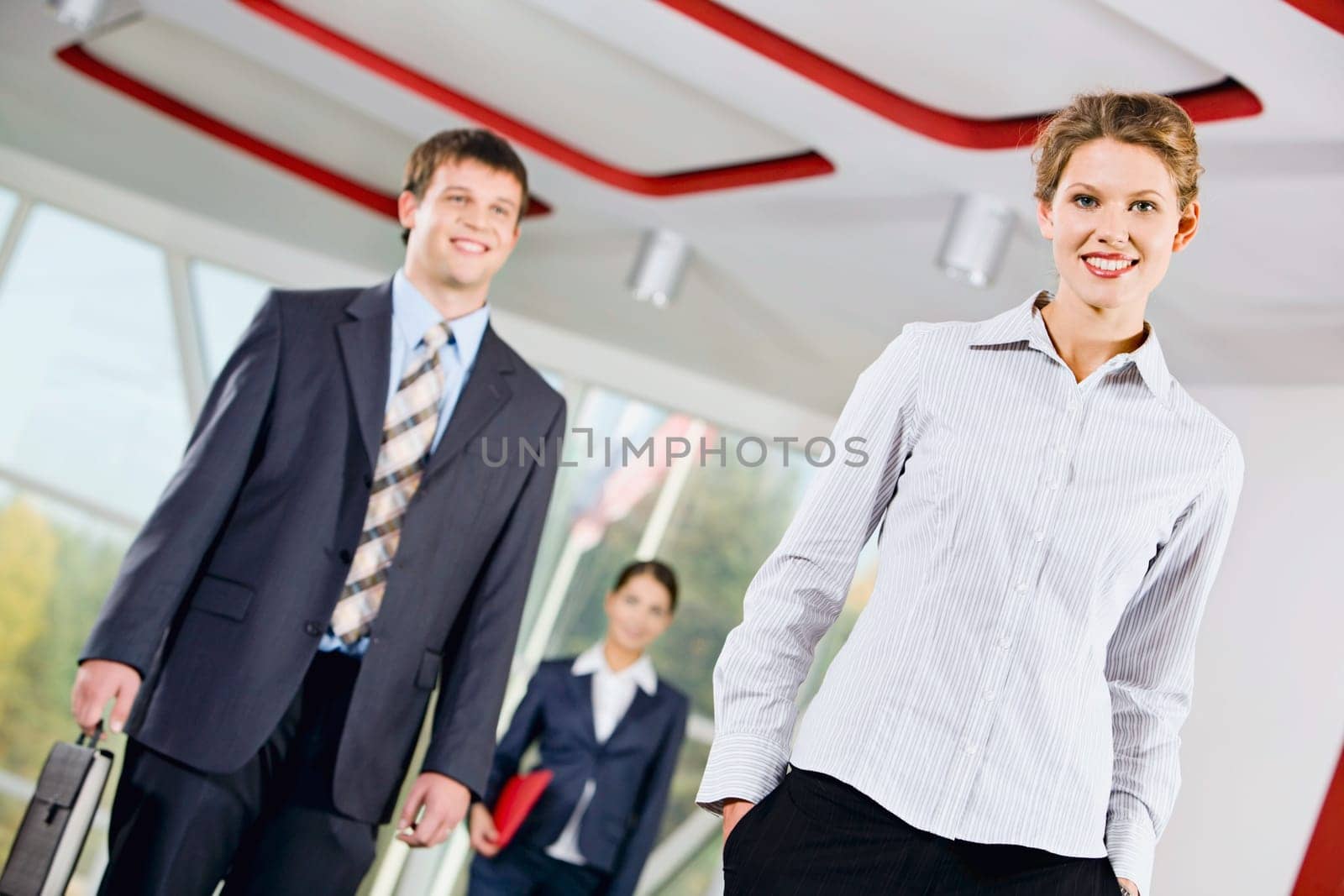 Confident woman standing in front of business people