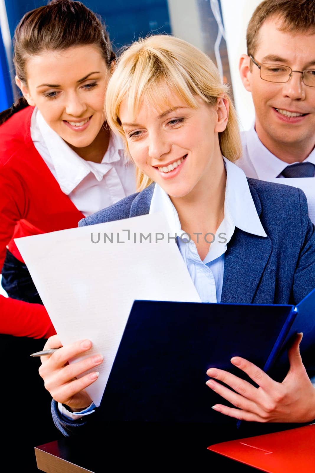 Portrait of successful entrepreneur reading a business-plan on the background of people