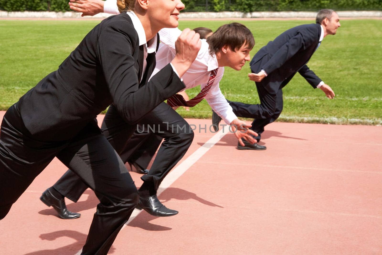 Image of active employees running on sport track