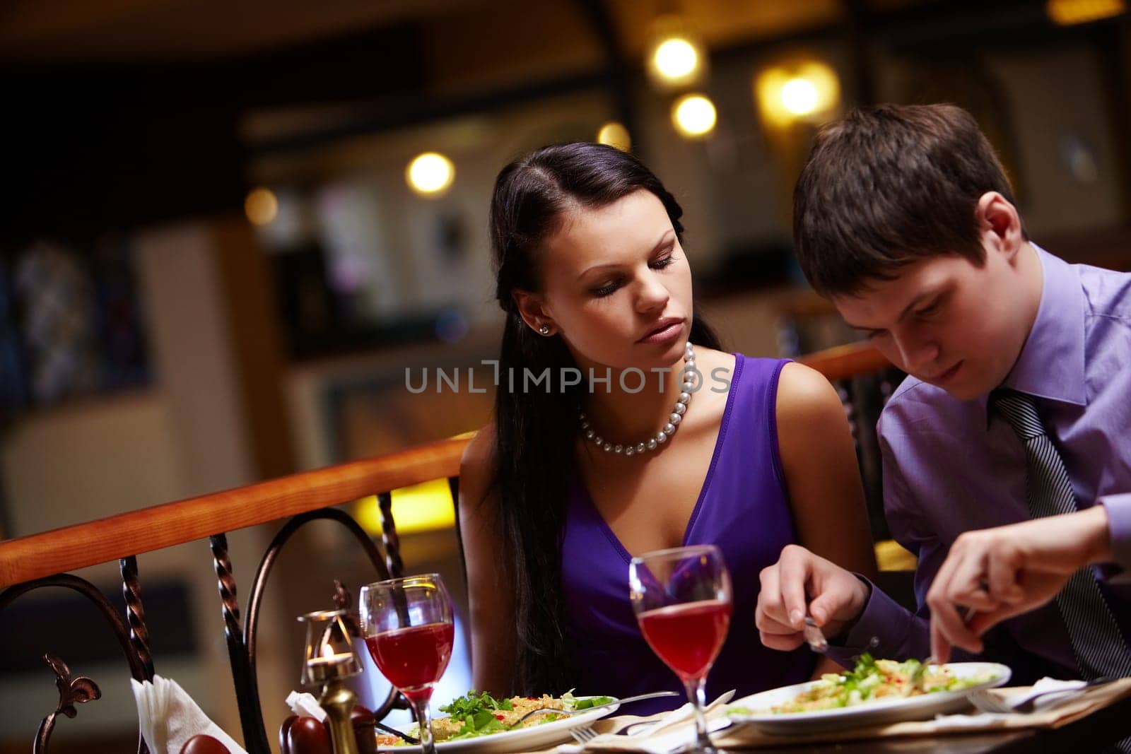 Portrait of hungry woman looking at mans food in cafe