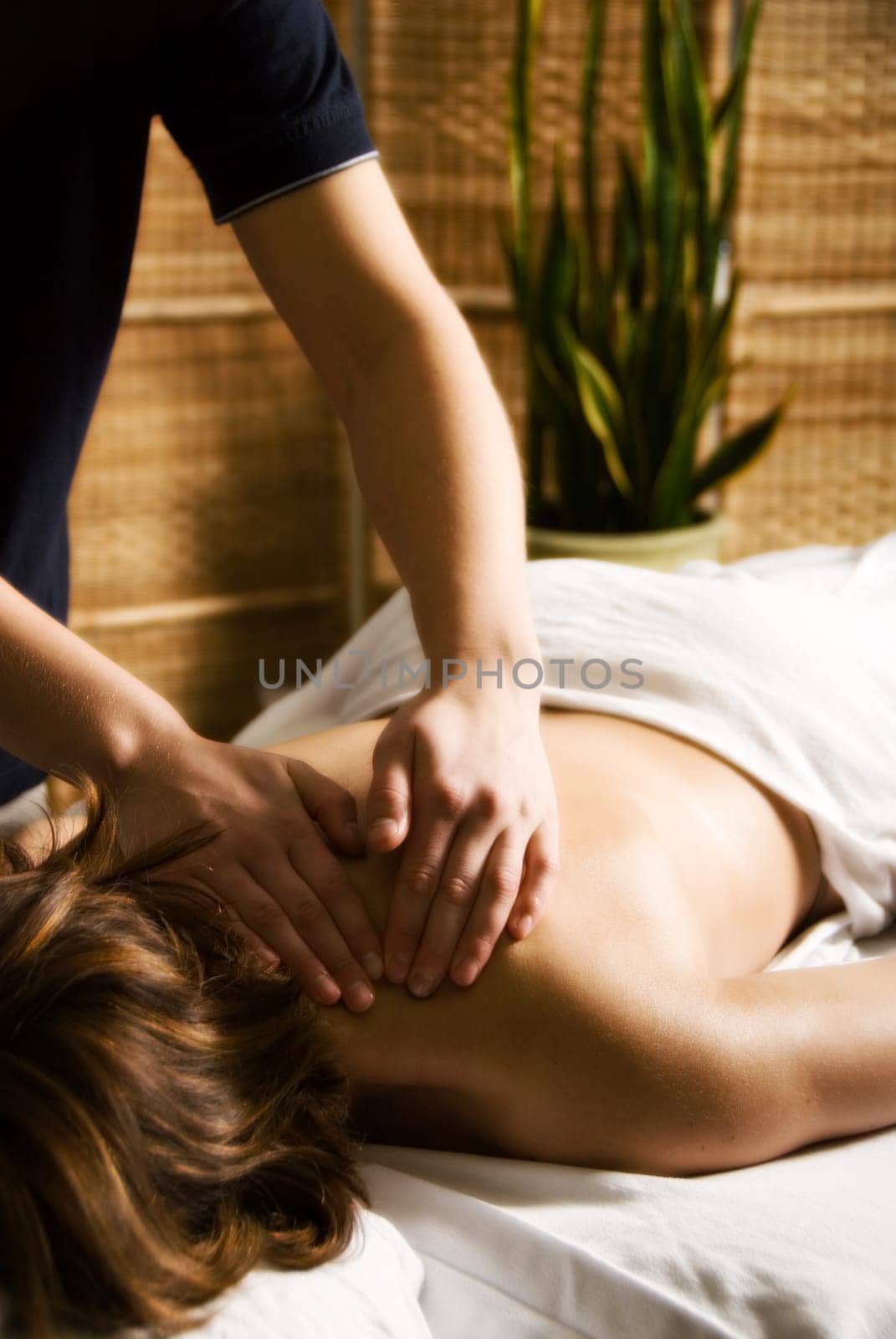 woman in a day spa getting a neck massage