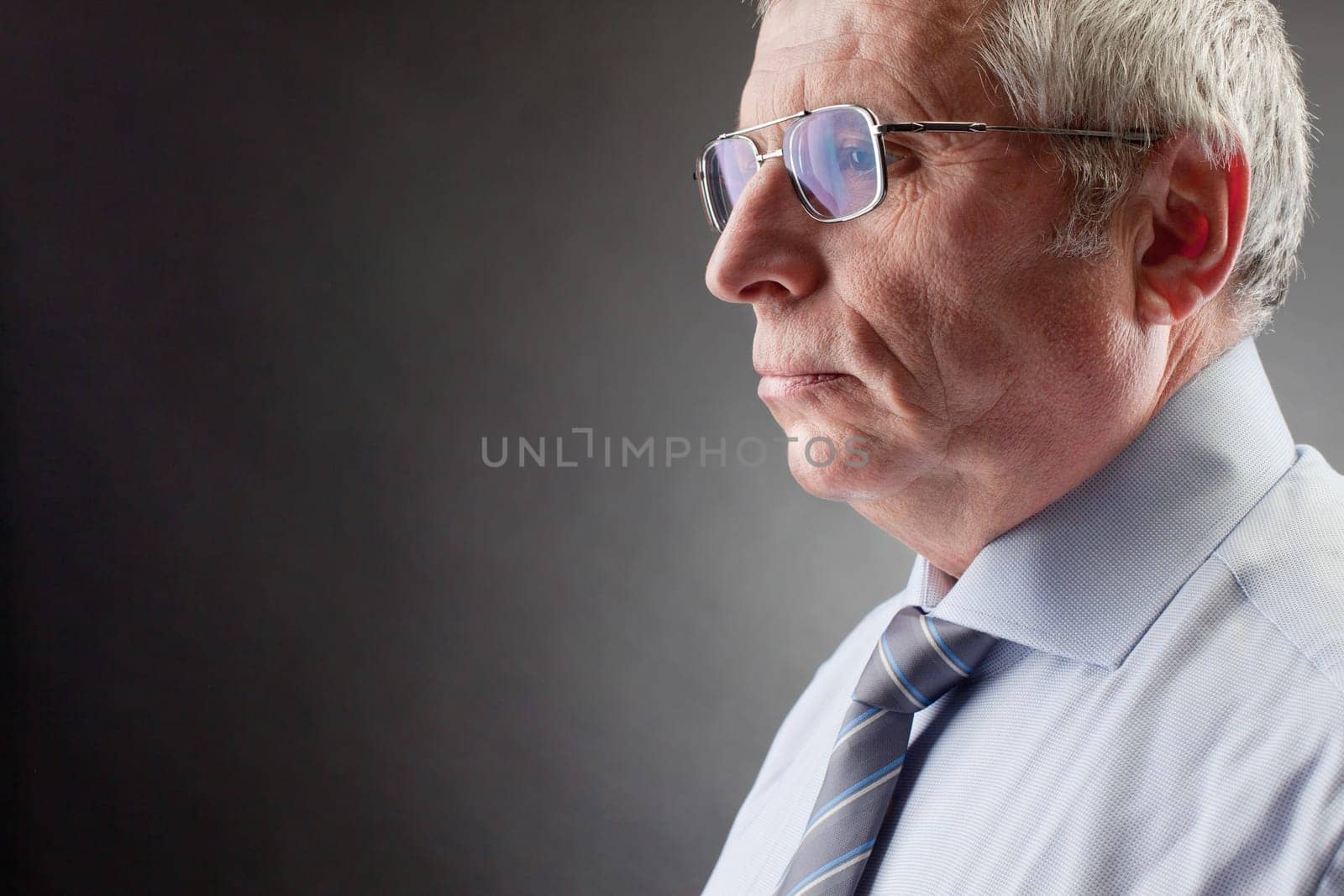 Photo of senior employer on black background