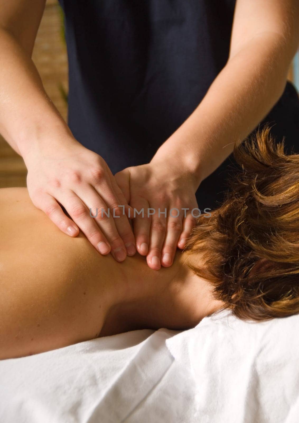 woman in a day spa getting a neck massage