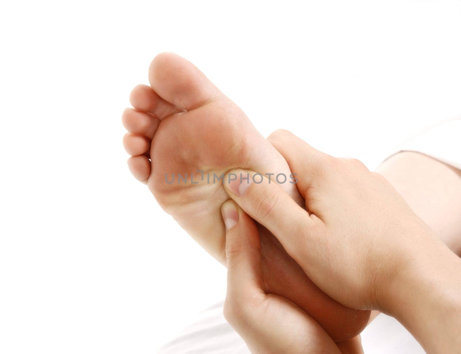 a foot massage given by a therapist in a spa