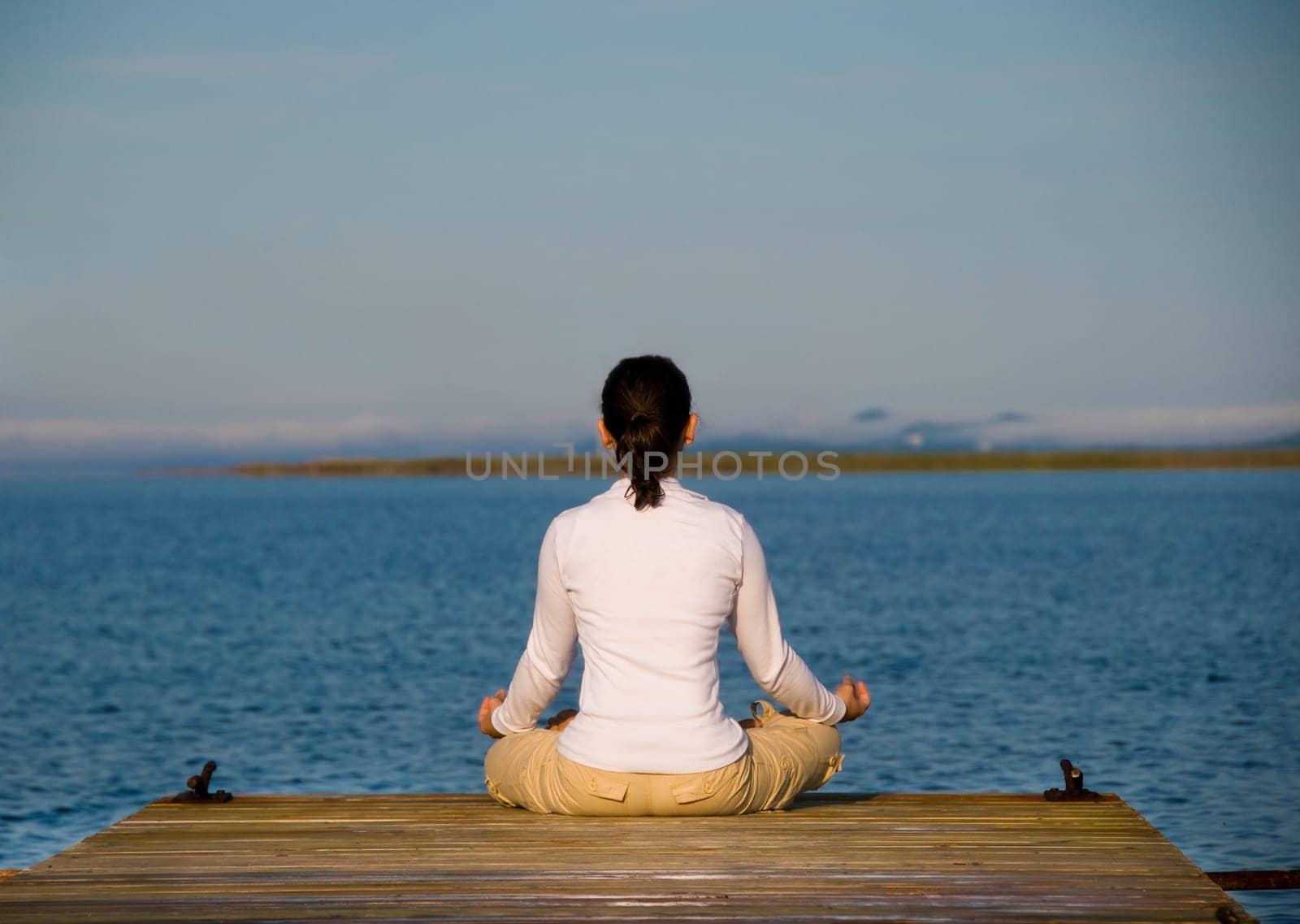 Yoga Woman on a dock by the ocean