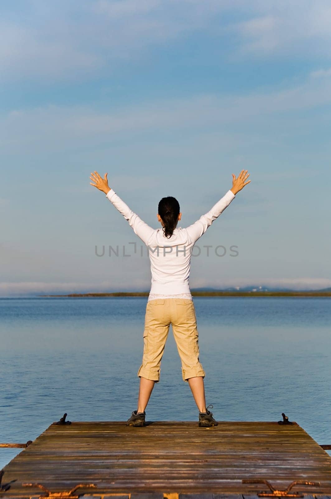 Yoga Woman on a dock by the ocean