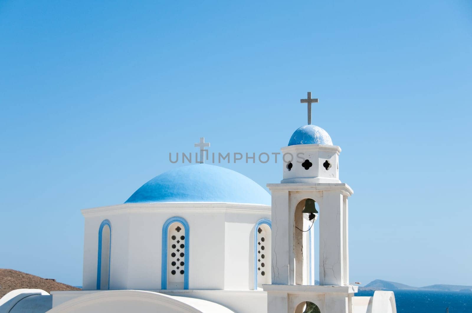 Greek church in santorini greece with a cross
