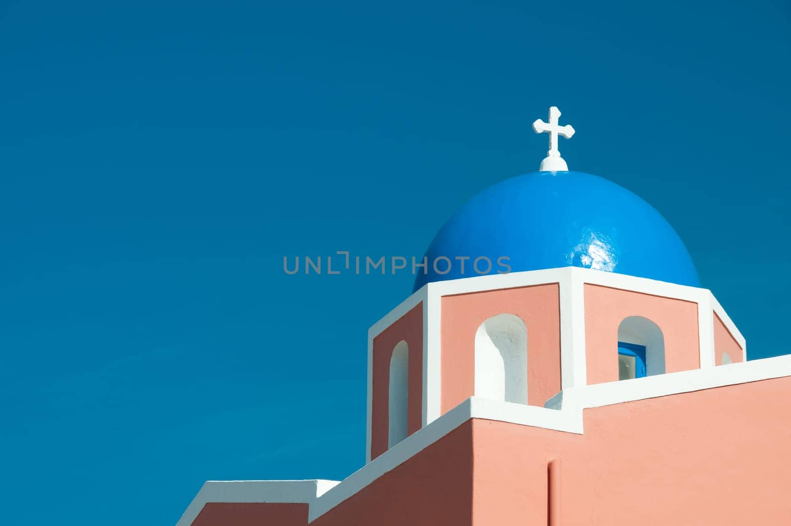 Greek church in santorini greece with a cross