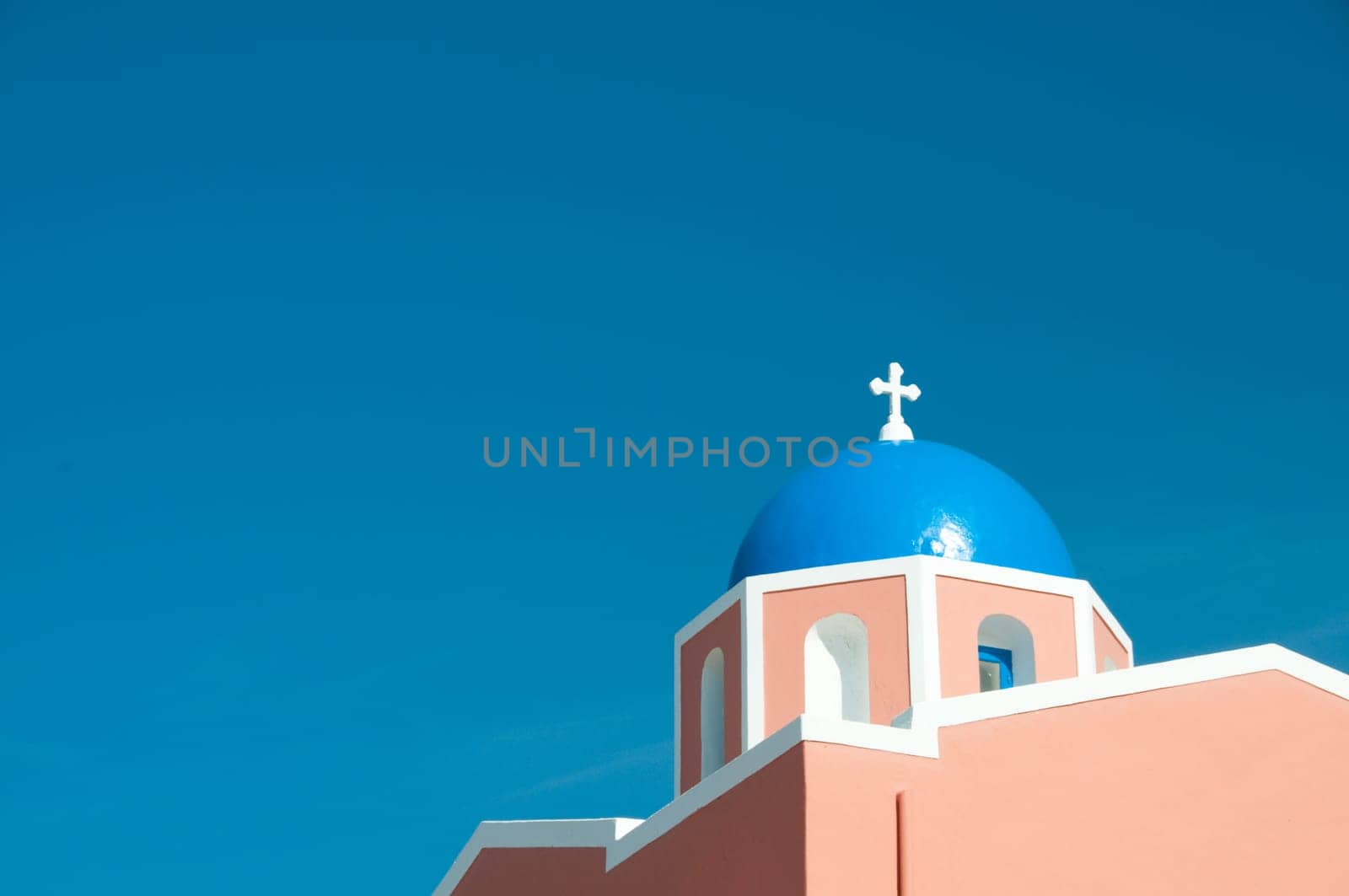 Greek church in santorini greece with a cross