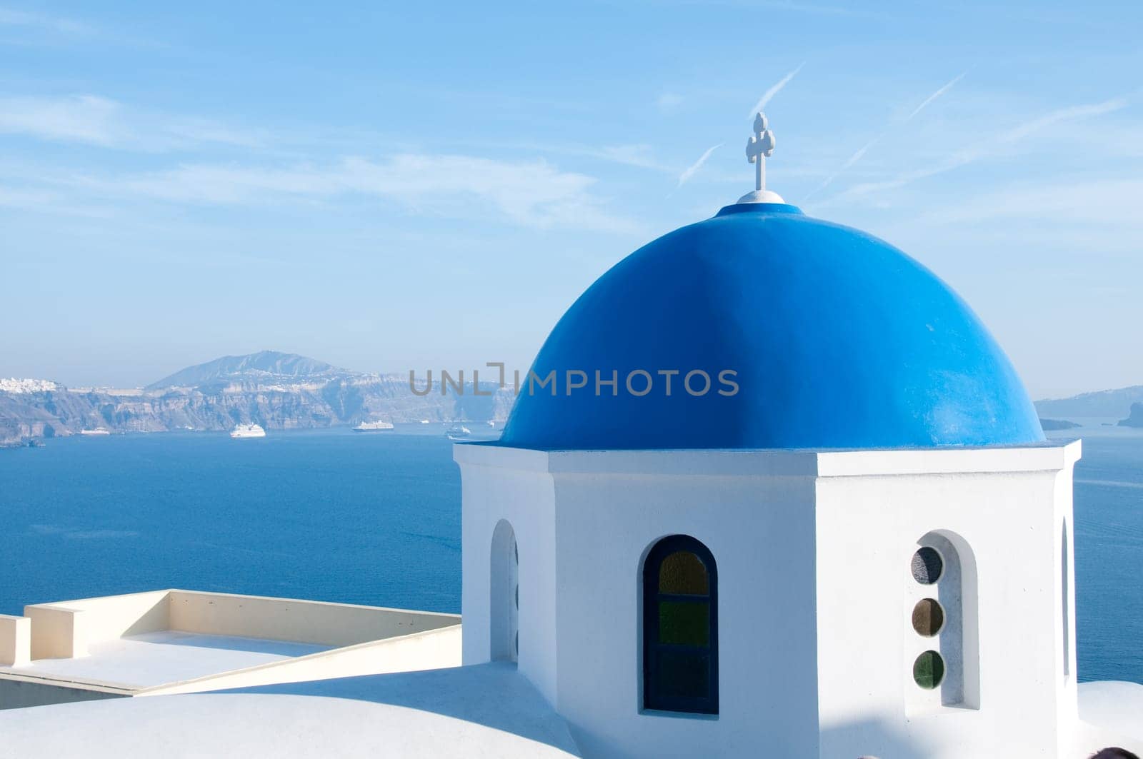 Greek church in santorini greece with a cross