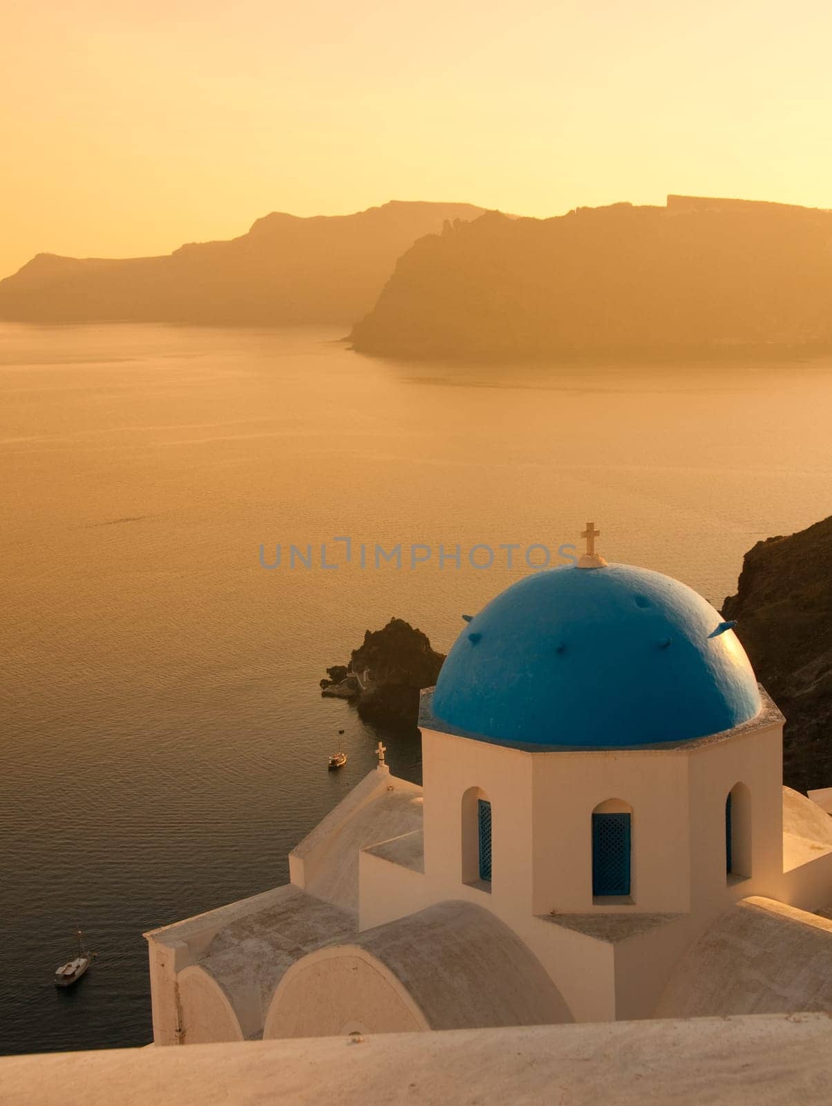 Greek church in santorini greece with a cross