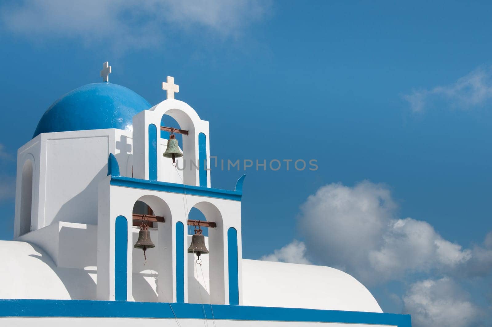 Greek church in santorini greece with a cross