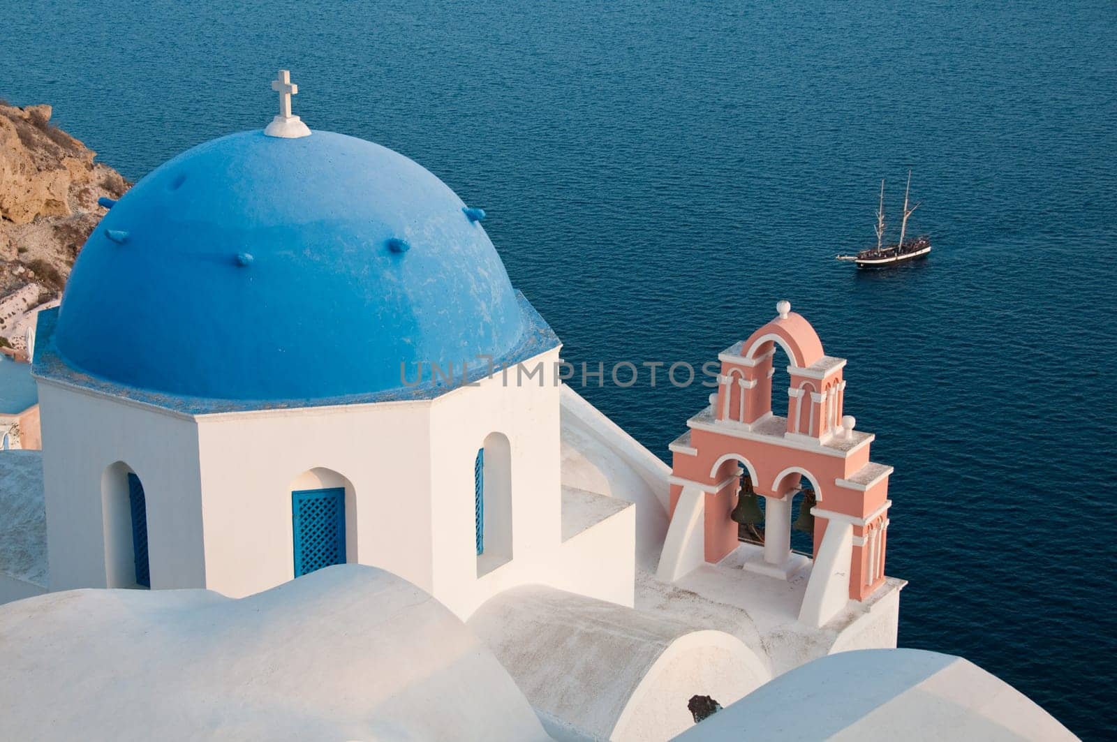 Greek church in santorini greece with a cross