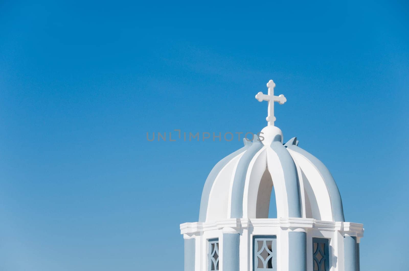 Greek church in santorini greece with a cross