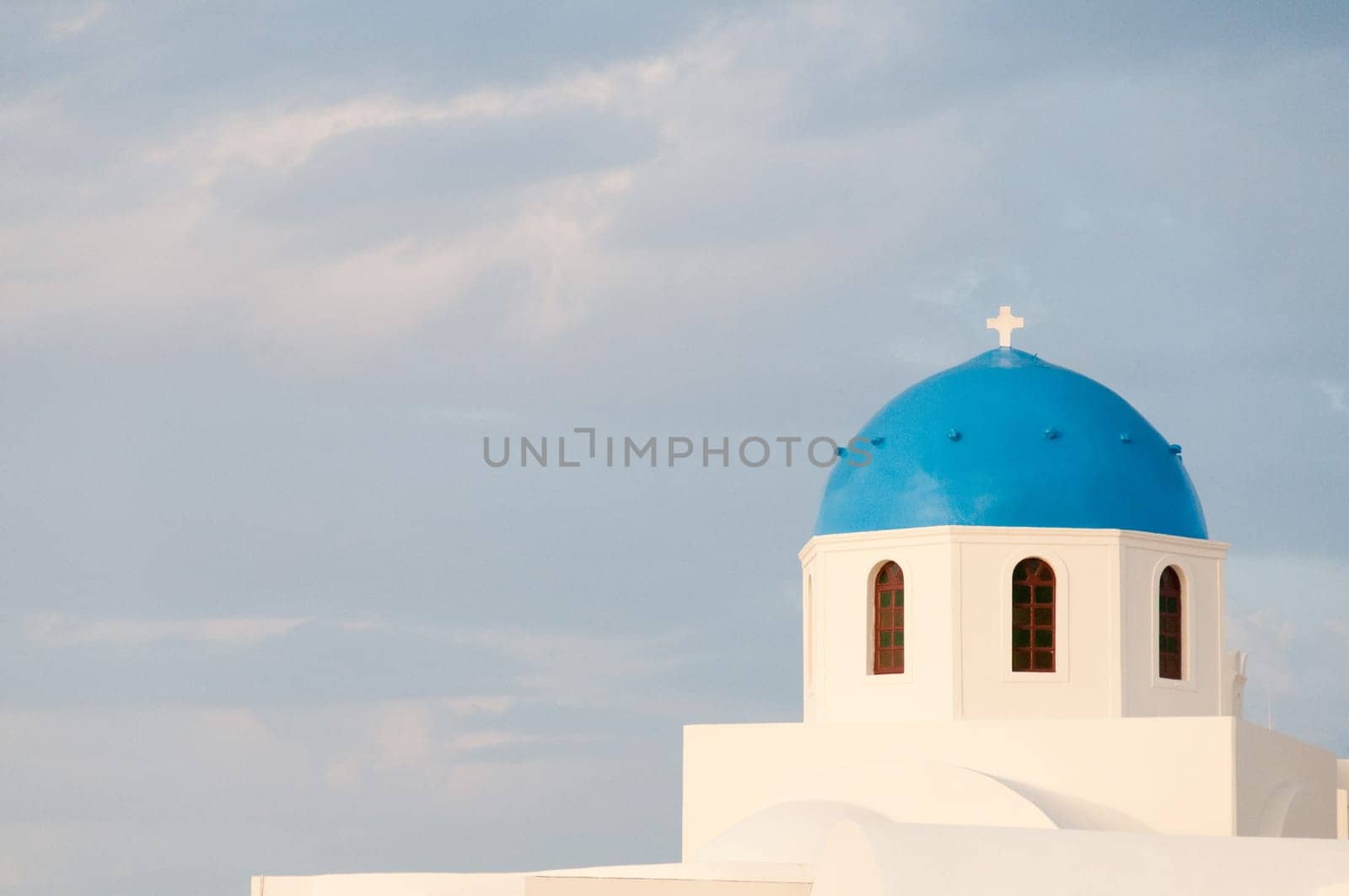 Greek church in santorini greece with a cross