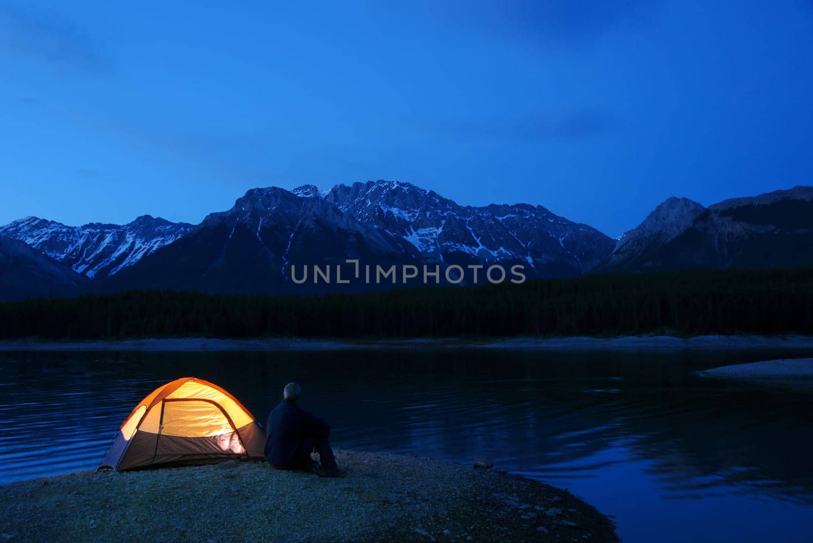Evening lit tent in camping by nature
