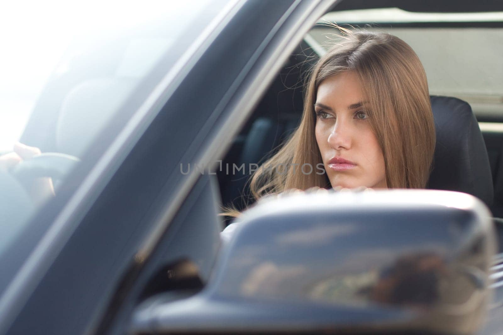 Image of pretty businesswoman in her car driving