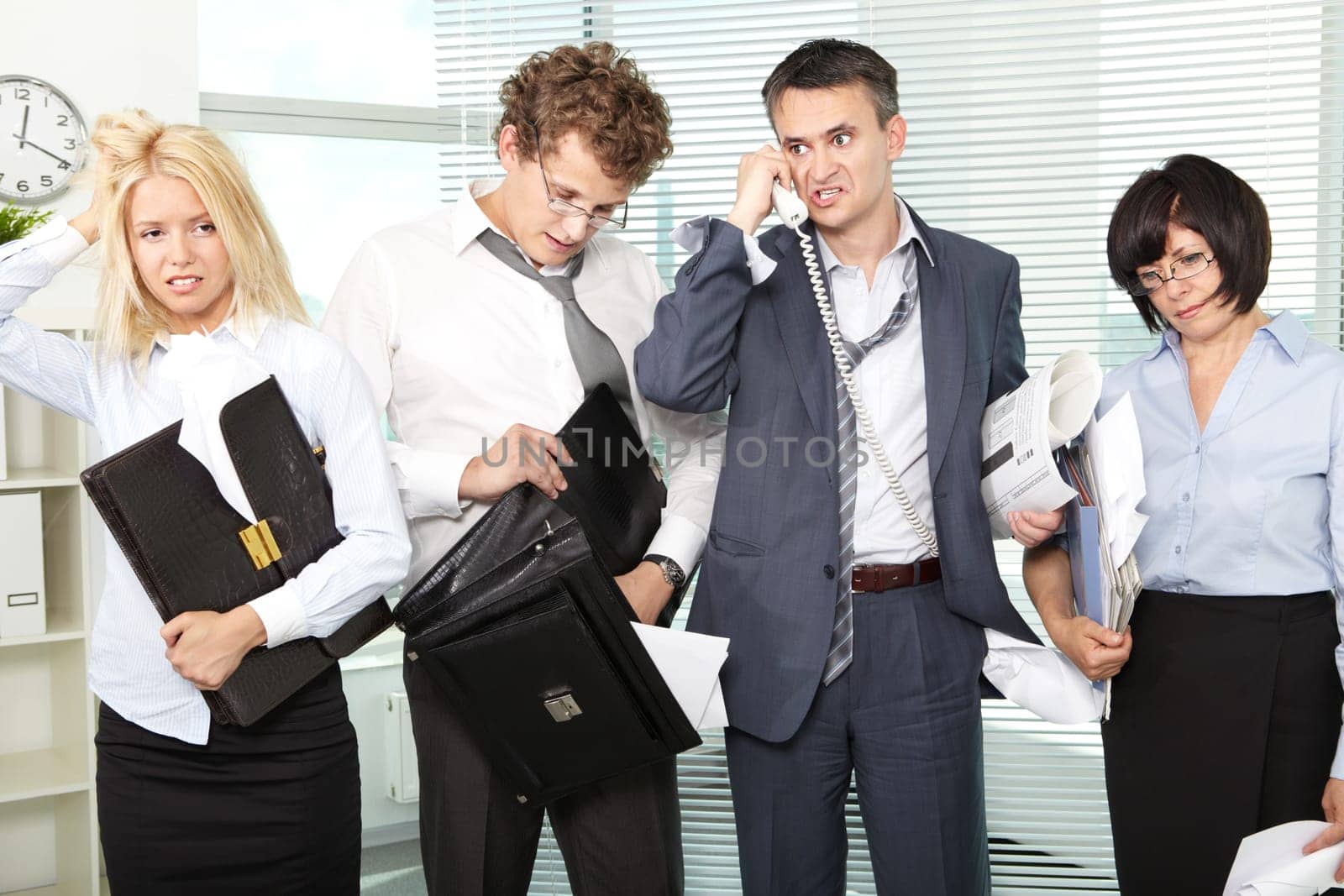 Group of tired and annoyed businesspeople after hard working day