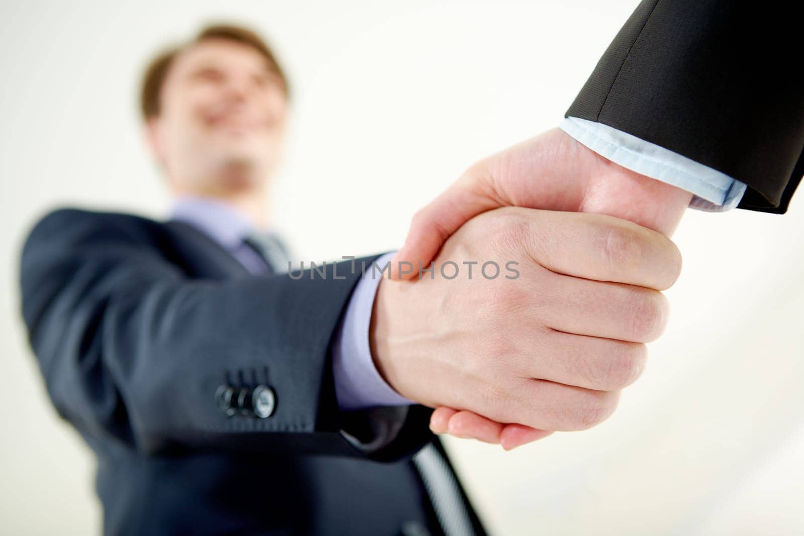 Image of handshaking of business partners on signing agreement
