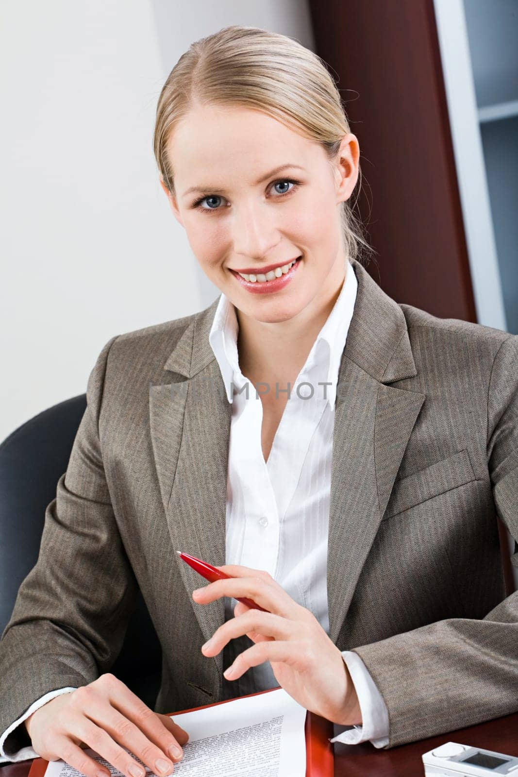 Portrait of bossy woman sitting at a table and looking at camera