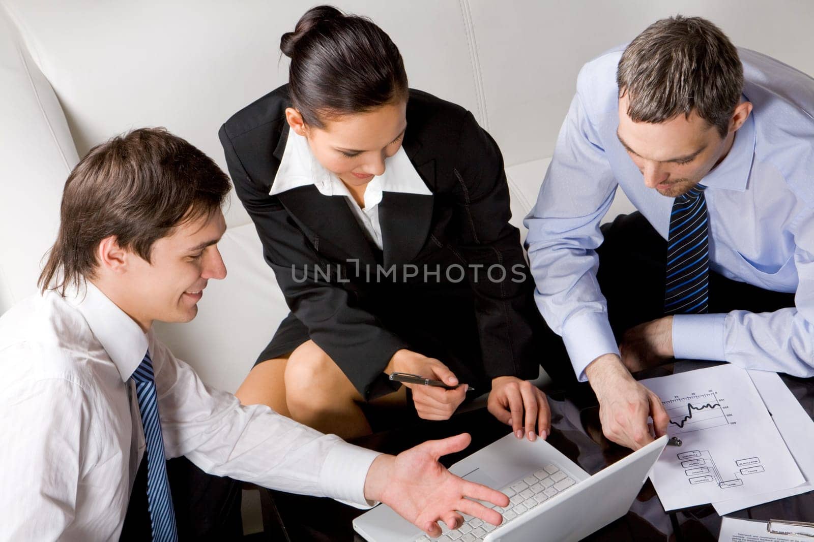 Photo of successful businessman explaining his point of view to colleagues at meeting