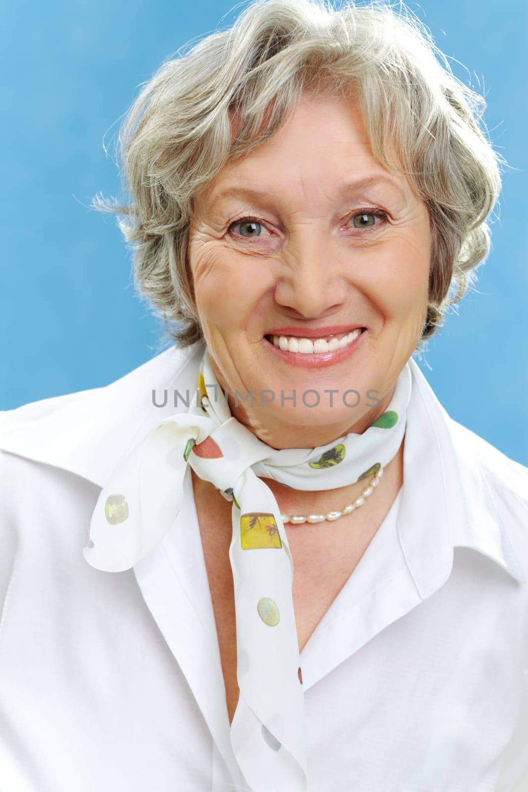 Portrait of happy elderly female looking at camera