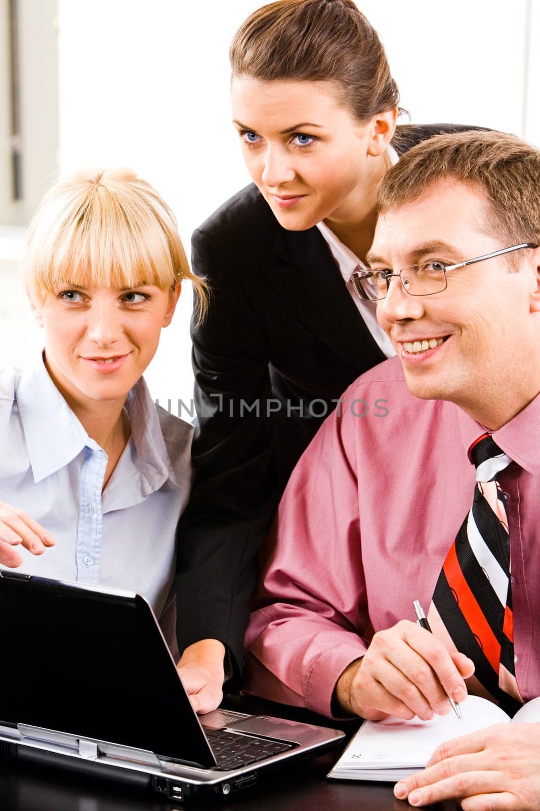 Portrait of three confident white collar offices looking at something