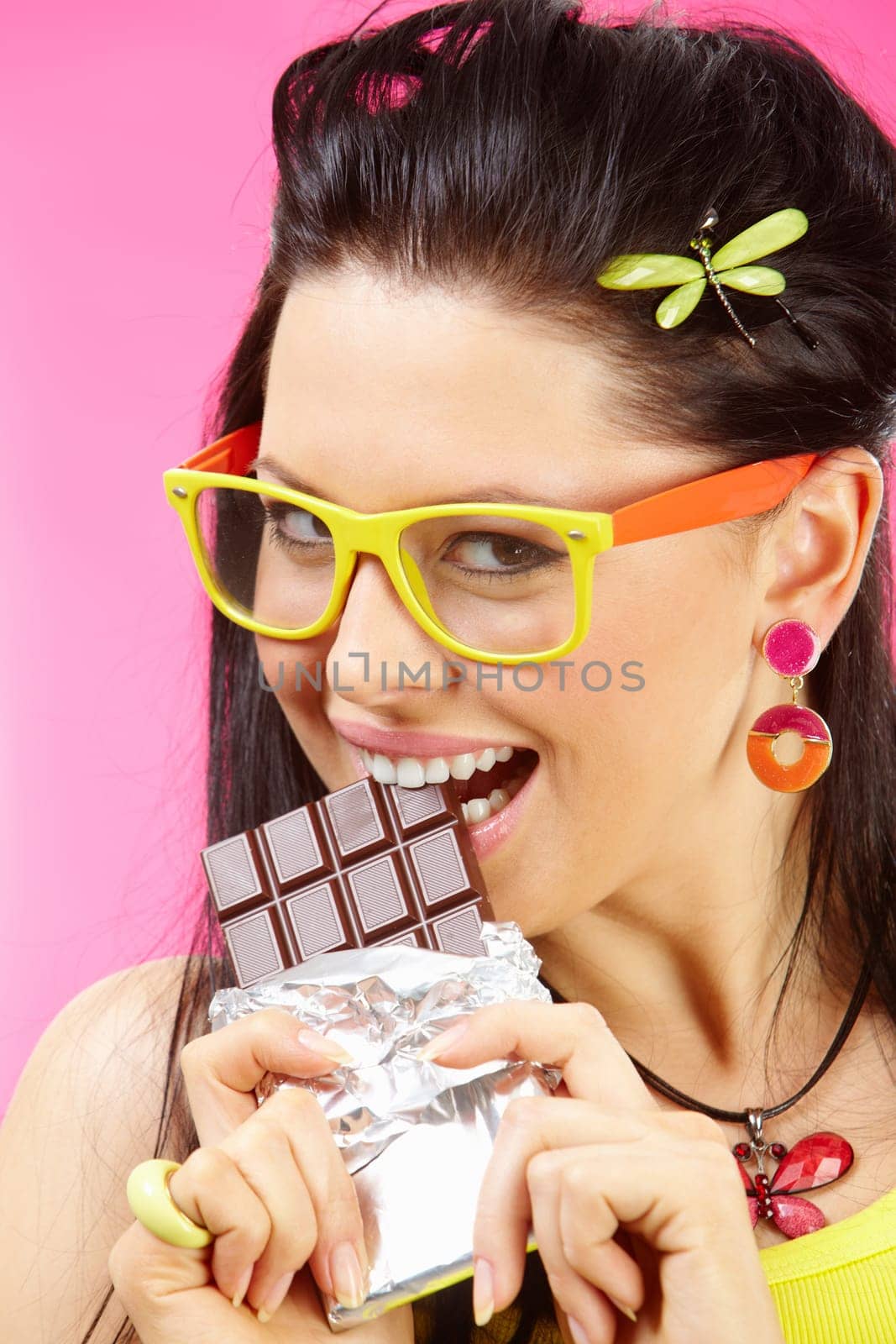 Portrait of pretty teenager eating chocolate