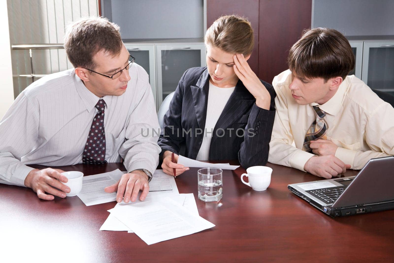 Group of three young business people are discussing a new plan