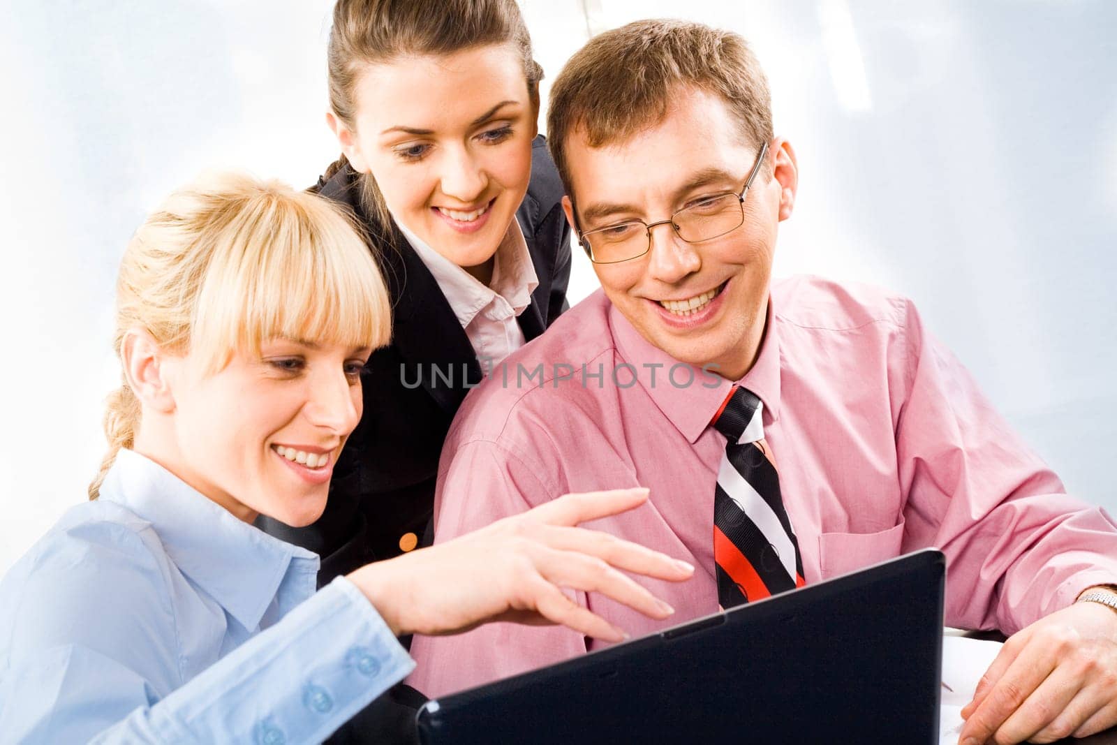 Portrait of three business people working together