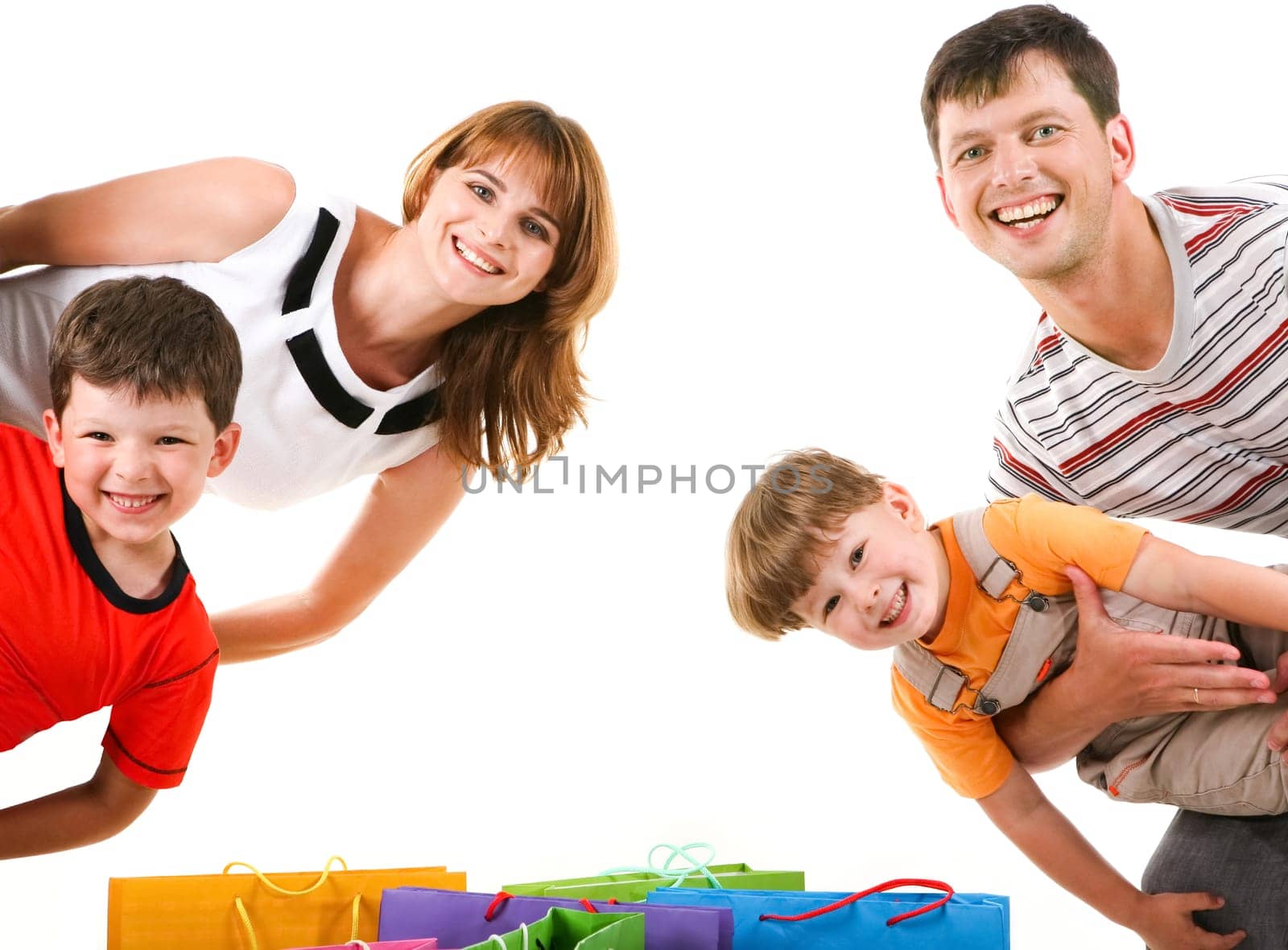 Image of cheerful family members standing looking at camera with happy expression
